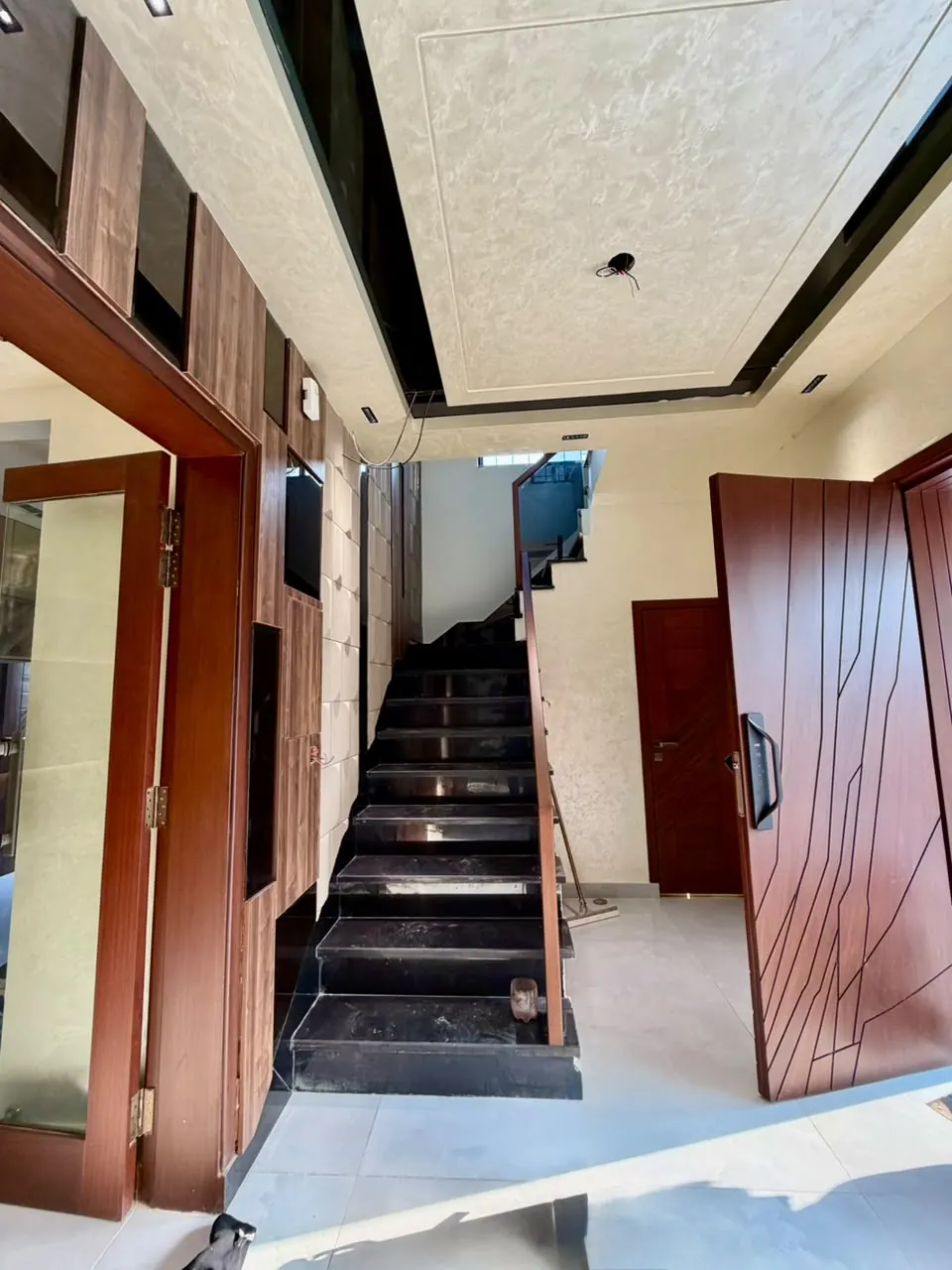 Entrance with wooden doors and staircase
