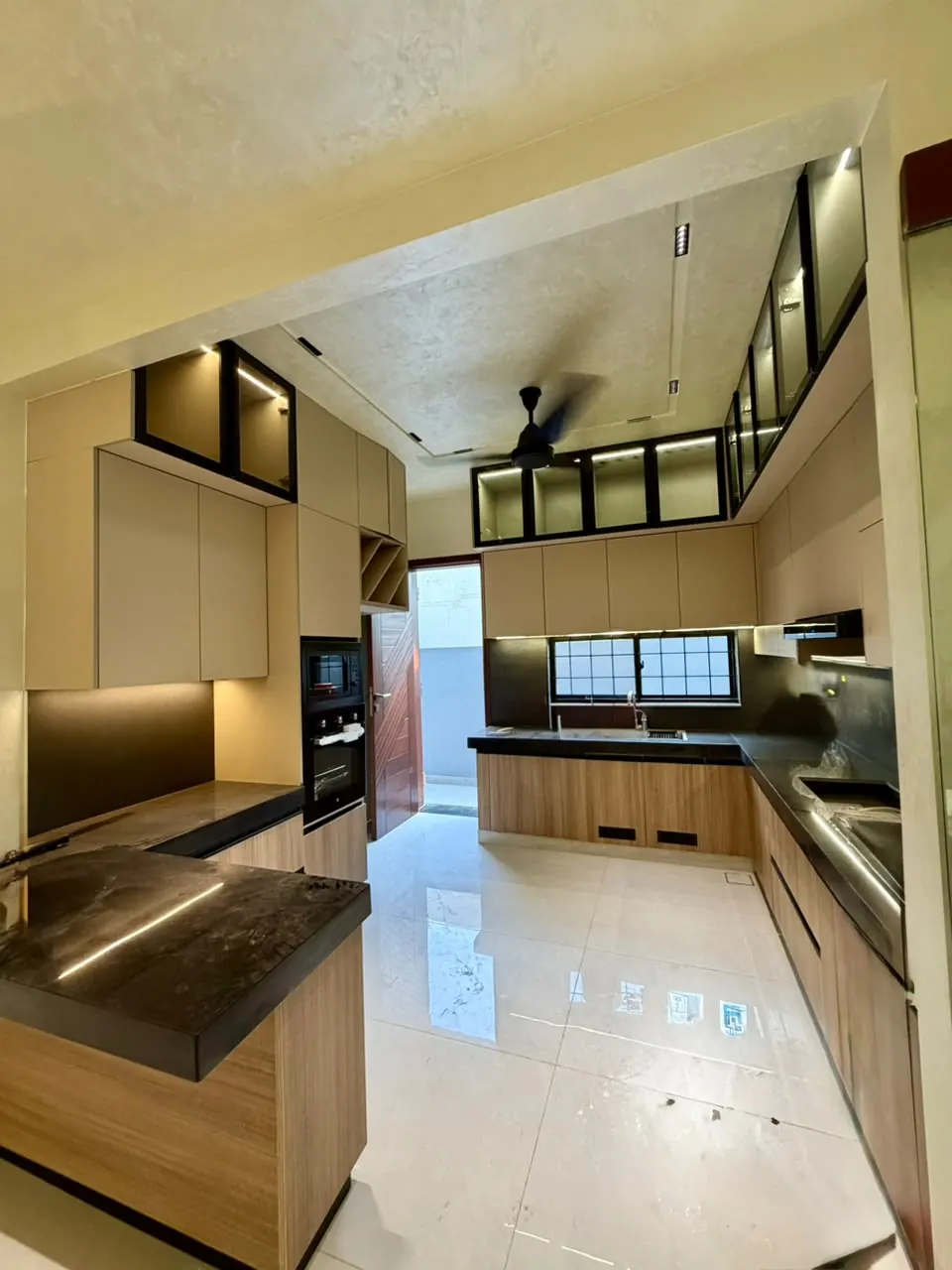 Kitchen with island counter and built-in oven