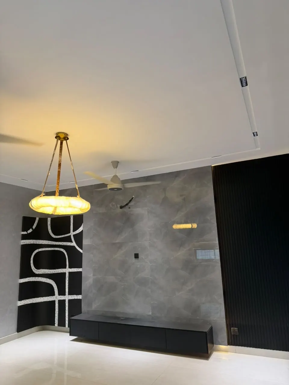 Lounge with chandelier and feature wall