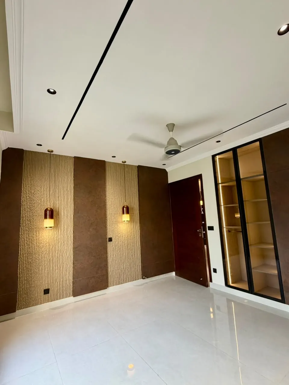 Bedroom with panelled wall and wall lights