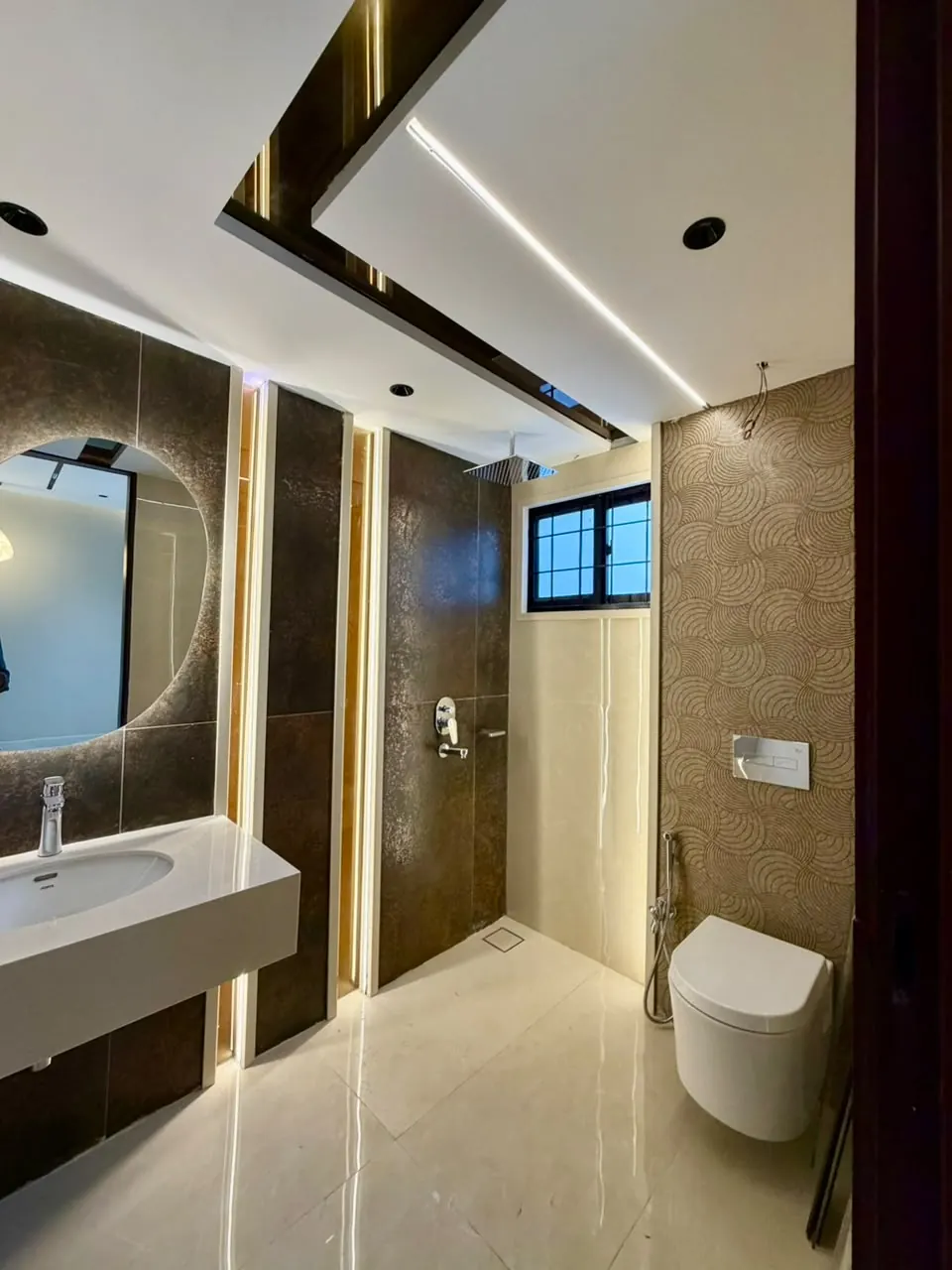Bathroom with wall-hung toilet and LED mirror
